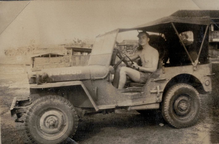 Ken Trotman (?) driving a Jeep